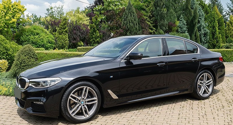 Black BMW 5 Series, front three-quarter view