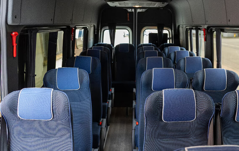 Ford Transit minibus cabin with blue and gray seats