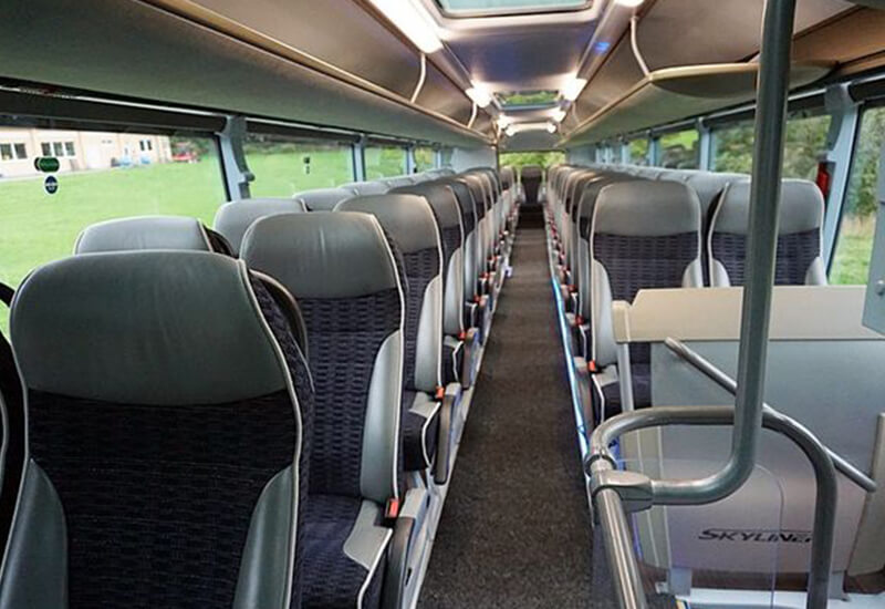 Neoplan Skyliner cabin with gray seats and a center aisle